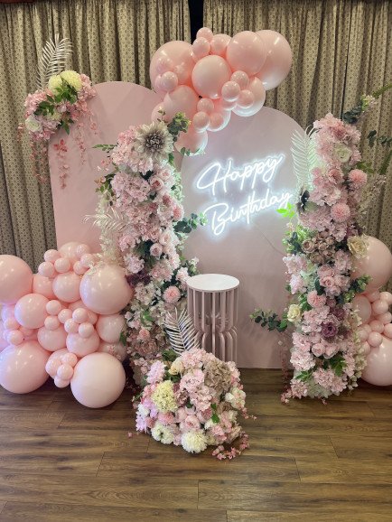 Sailboards with neon light, floral column, balloon garland and cake plinth