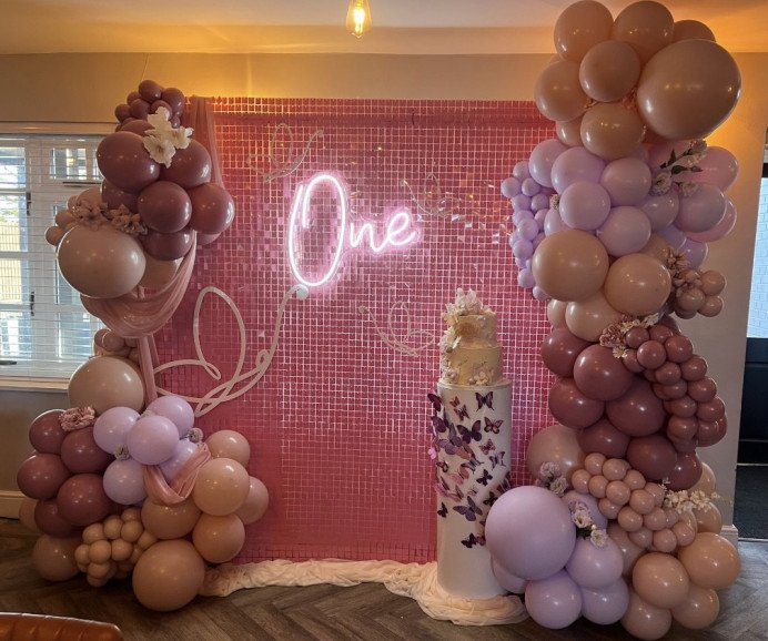ONE'derful themed 1st Birthday backdrop, featuring our bubblegum pink shimmer wall, balloon display, cake plinth & acrylic butterflies