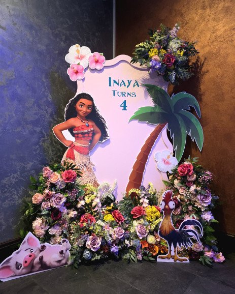 Moana-themed birthday party setup with tropical flowers, palm tree backdrop, and Disney characters at Blue Ginger Kenton.