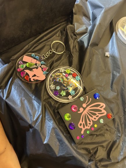 My students artwork designing their vinyl mirrors, pin badges and keyrings using handmade stencils I designed and decorating with gems