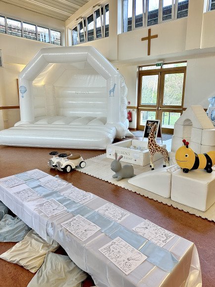 Our white bouncy castle with personalisation, picnic tables and soft play