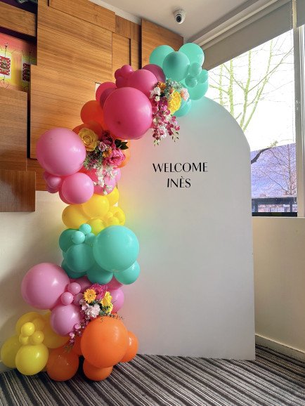 Colourful balloon garland with personalised backdrop