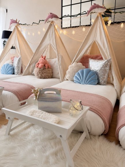 Three teepees styled for our Mermaid Lagoon theme, with plush whale toppers, fairy lit fishing nets and soft blush and blue cushions. Every detail makes little ones feel washed up somewhere magical.